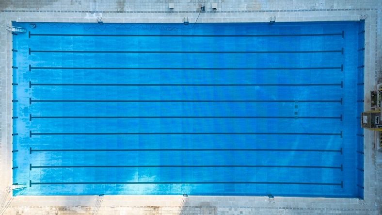 Top-down view of a swimming pool surface and lanes