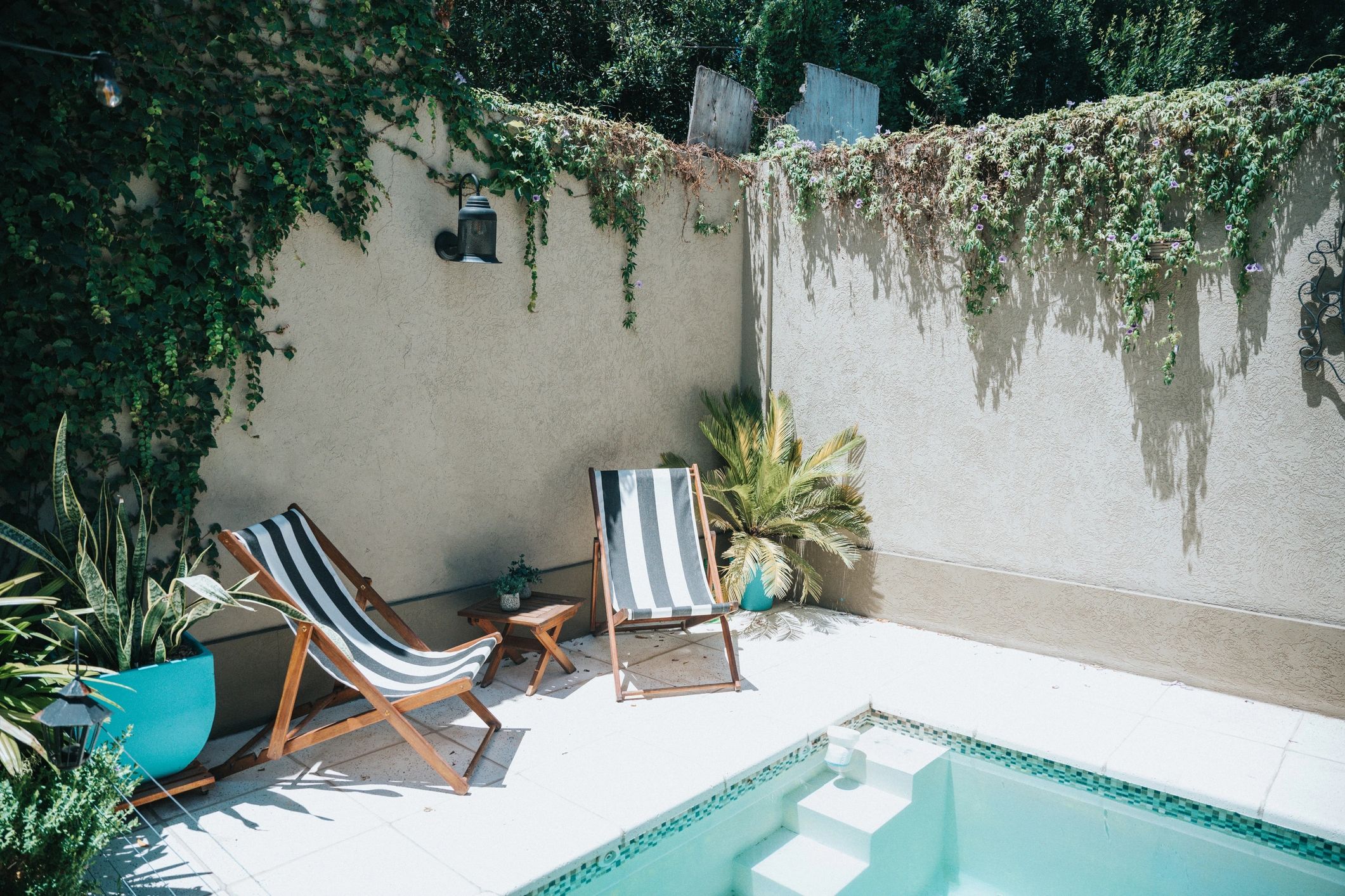 Backyard pool with loungers—representing solar pool cover benefits