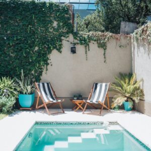 two sun chairs at swimming pool in patio
