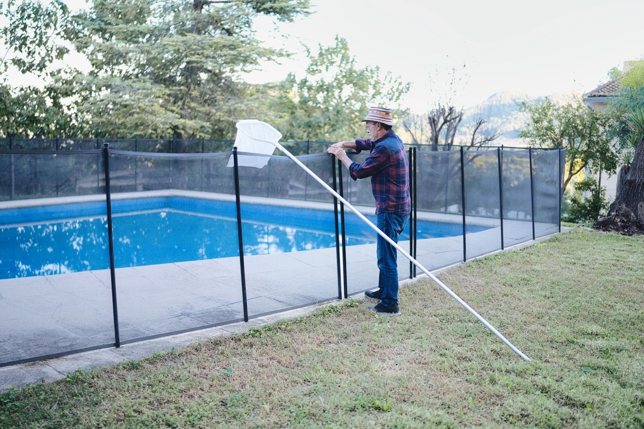 Technician performing routine pool-side maintenance